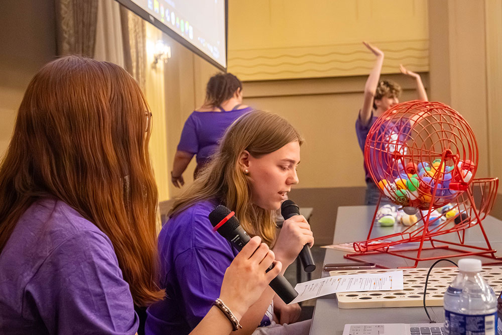 Two students call bingo numbers.