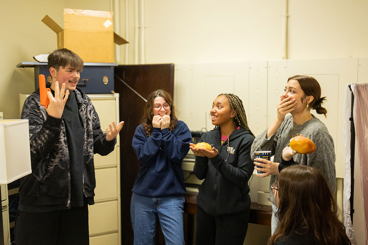 Students talk in the CSI House.