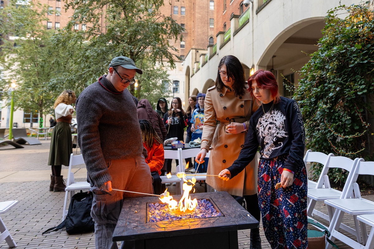 Students roast s'mores in Village Park. 