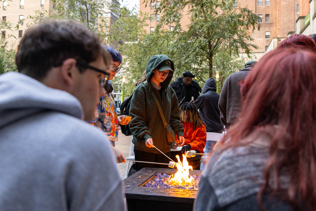 Students roast s'mores in Village Park. 