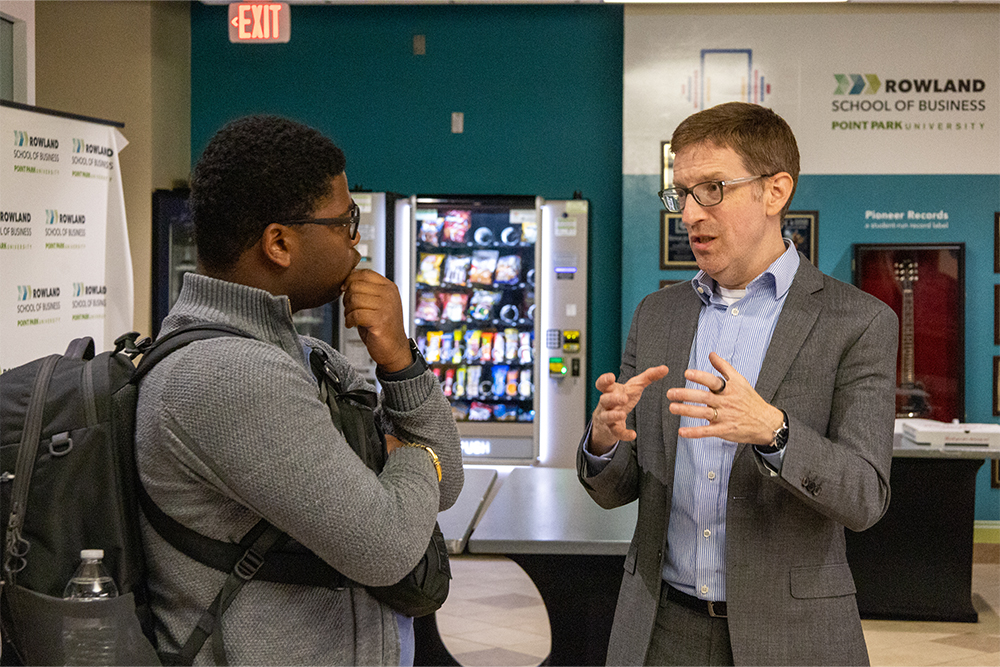 Geoff Anisman, Deputy Assistant Secretary for Preservation and Global Platforms at the U.S. State Department's Bureau of Educational and Cultural Affairs, chats with a student in the Michael P. Pitterich Sales and Innovation Center at Point Park University on Sept. 24, 2026. 