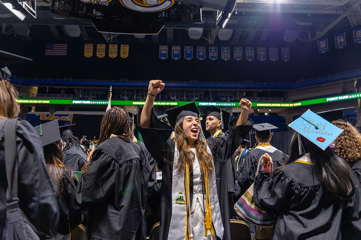 A female graduate celebrates.