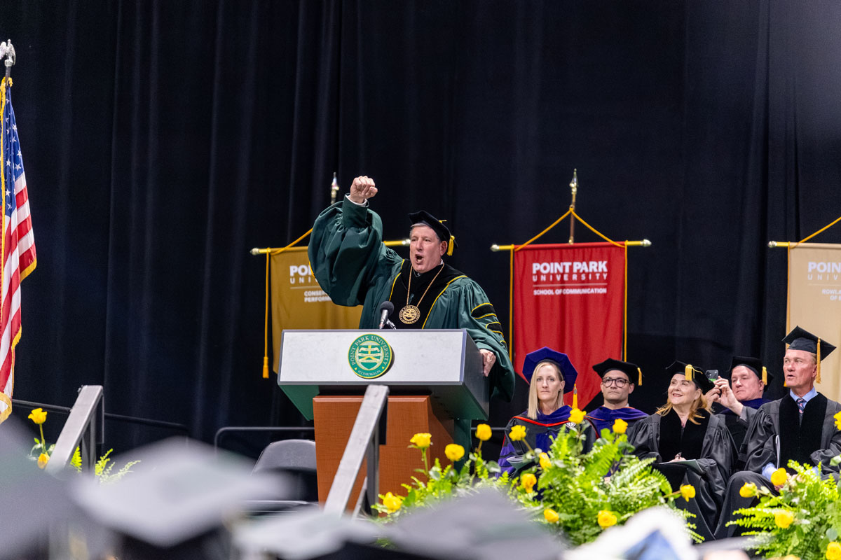 Chris Brussalis raises his hand in the air.