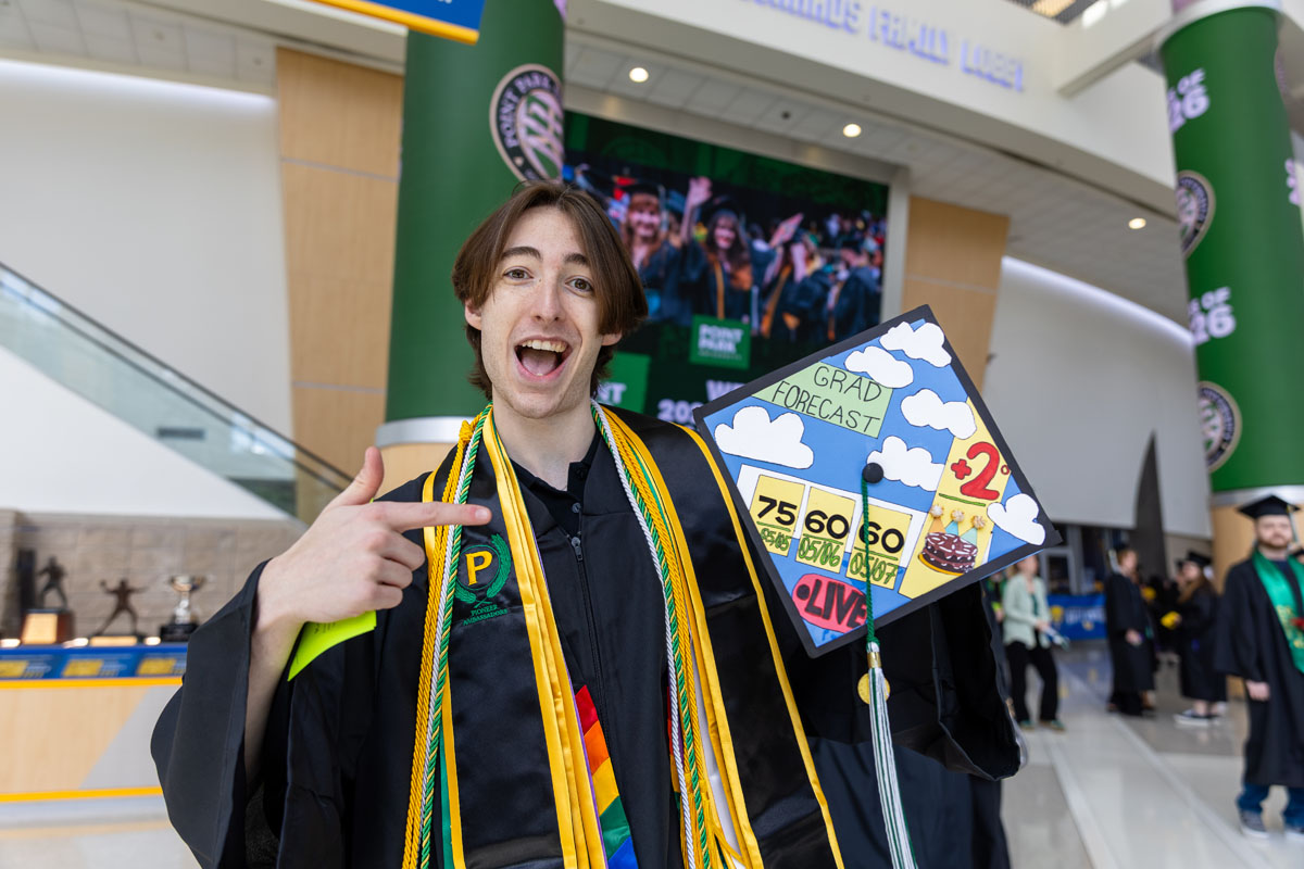 A graduate poses with his decorated cap.
