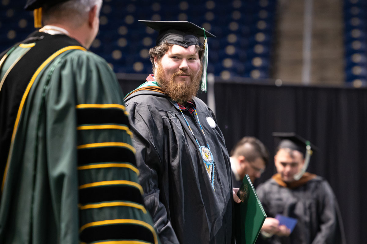 A graduate looks at the president.