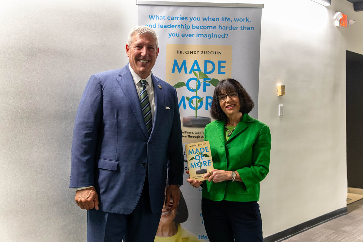 Cindy Zurchin, part-time instructor, with President Chris W. Brussalis at the Voices of Excellence in Education Speaker Series.