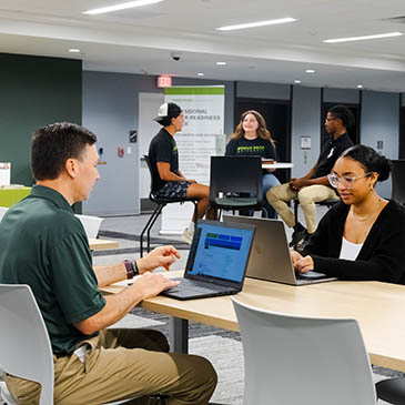 Students and staff interact in the university's Professional Career-Readiness Center. 