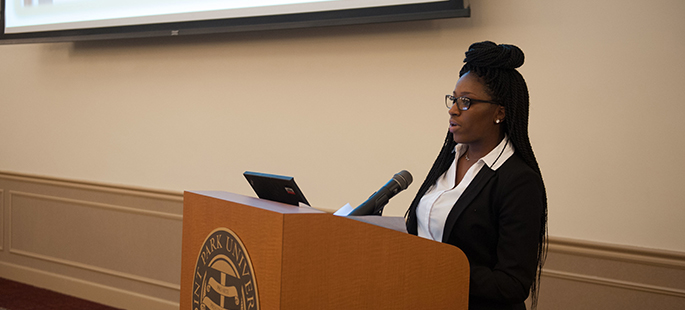 Pictured is a graduate student presenting research. Photo by Sarah Collins