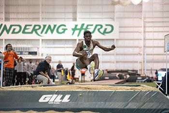 Pictured is Akeem Mustapha competing in the long jump.