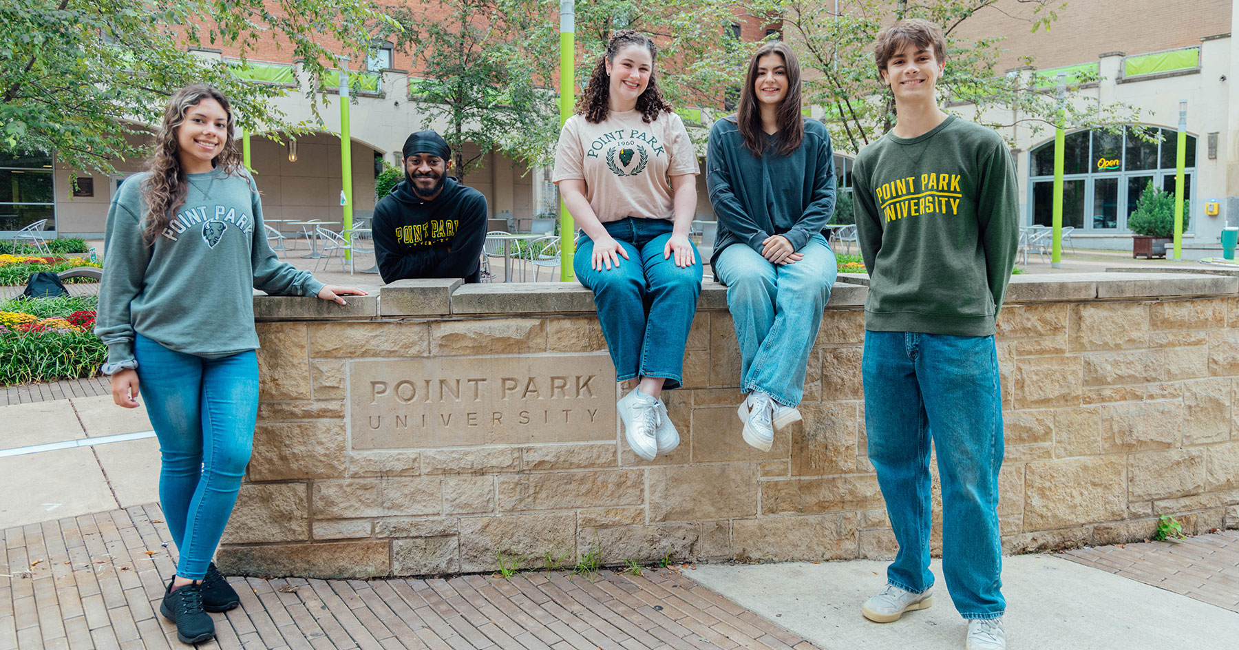 Students in Village Park next to a Point Park sign. Photo | Ethan Stoner