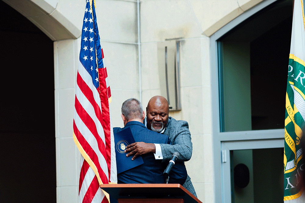 Dr. Chris W. Brussalis embraces Jake Wheatley