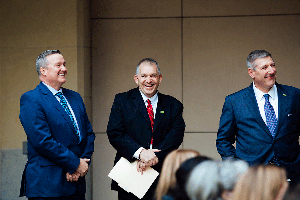 Ted Black, Keith Paylo and Chris Brussalis stand laughing