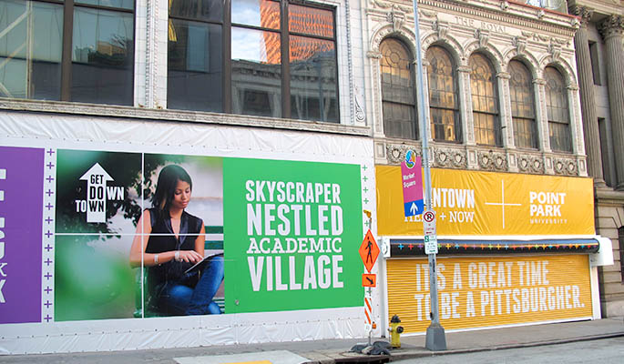 Colorful banners promoting the City of Pittsburgh's new Downtown Action Strategy to promote retail development in the Golden Triangle. The banners are located on Point Park University buildings along Forbes Avenue.