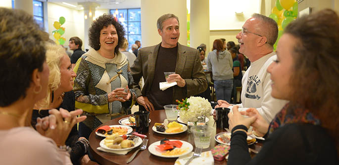 Point Park President Paul Hennigan and his wife, Colleen, talk with Point Park families and students at the President's Reception, part of Family Weekend 2012. | Photo by Jim Judkis