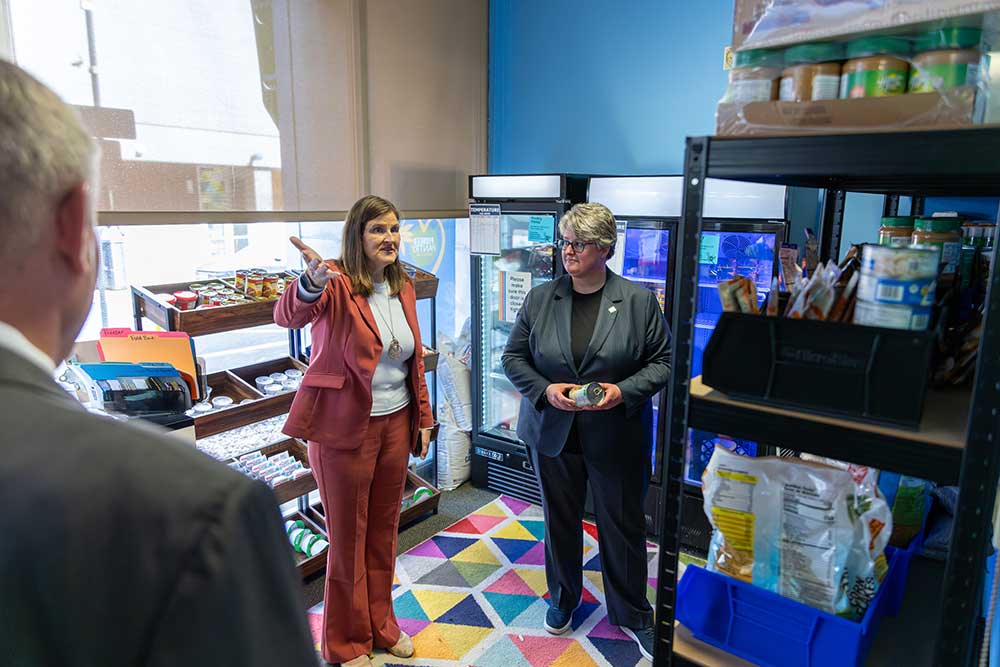 Heather Starr Fiedler gives Carrie Rowe a tour of the Corner Store