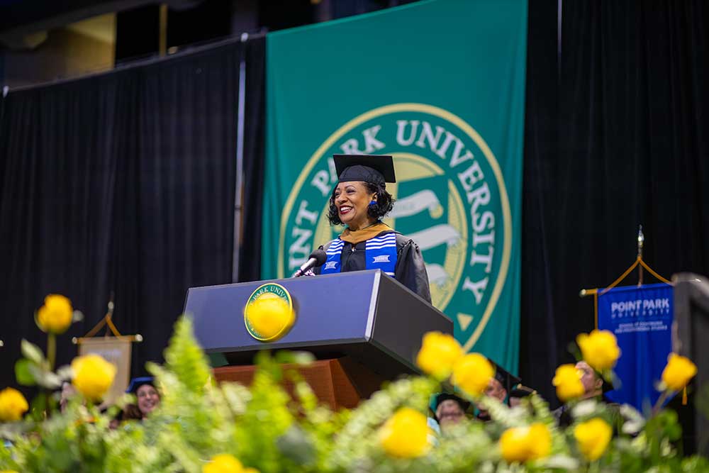Tanika Harris speaks from a podium.