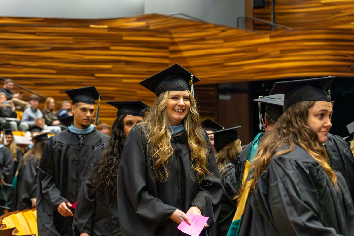 Graduates file into their seats.