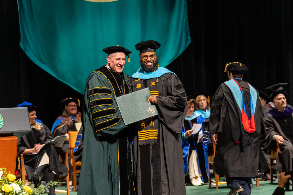 A student poses with Dr. Brussalis.