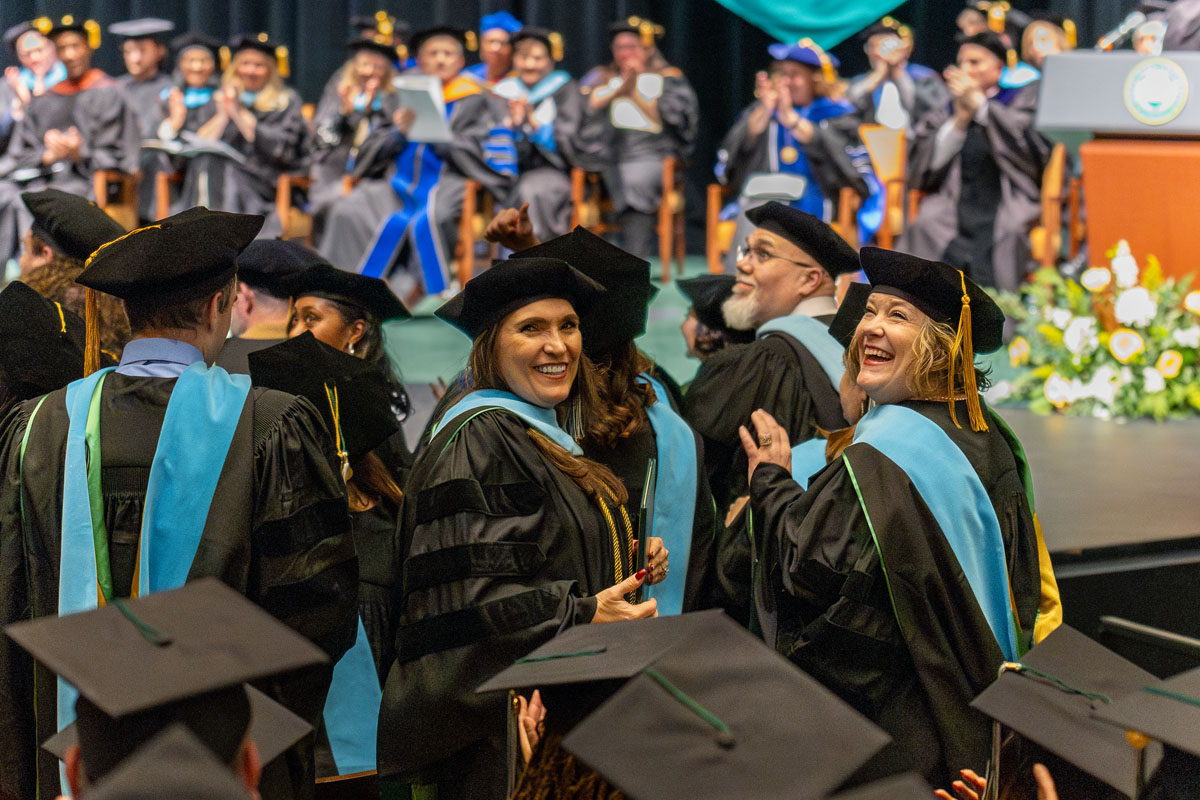Graduates pose for a photo.