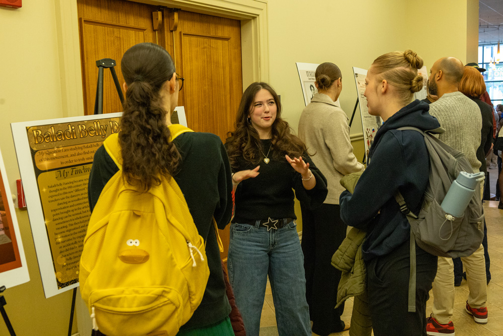Students discuss their research projects at the Fall Forum in December 2025. 