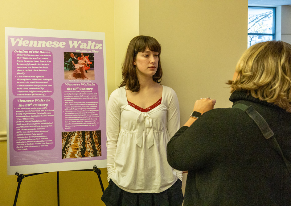 Students discuss their research projects at the Fall Forum in December 2025. 