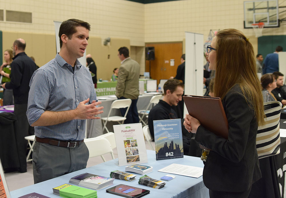 Jack Dougherty, Pittsburgh Downtown Partnership, talks to Emily Breen, a senior marketing major at Grove City College, at a 2017 internship and career fair. Photo by Gracey Evans.