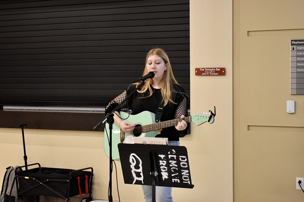 Student Bella Wilson played the guitar and sang during the Pioneer Pause welcome breakfast. Photo by Nicole Chynoweth.