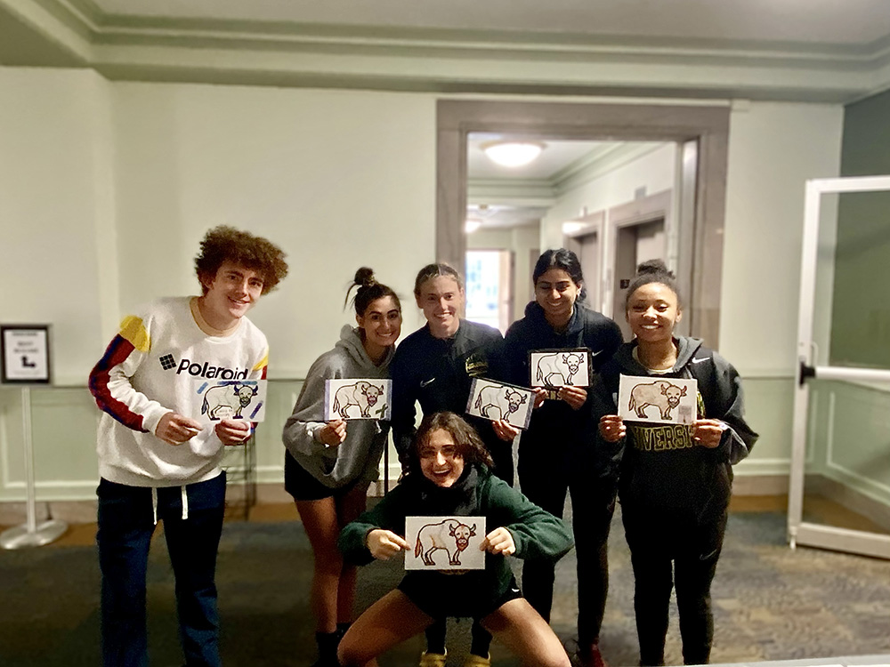 Students pose for a photo at the coloring station at the Pioneer Pause.