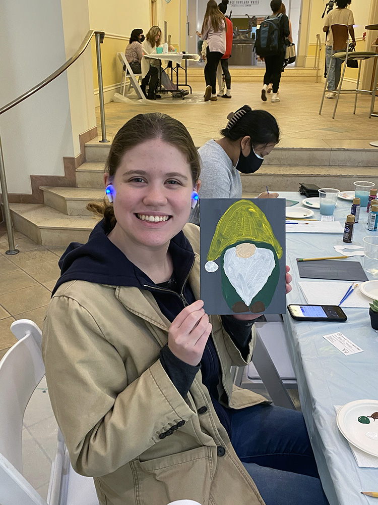 A student poses with her gnome painting at the Pioneer Pause.