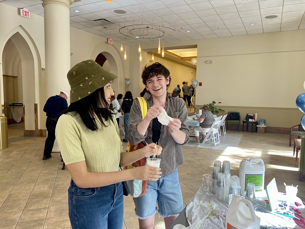 Two students take part in the slime station during the Pioneer Pause.