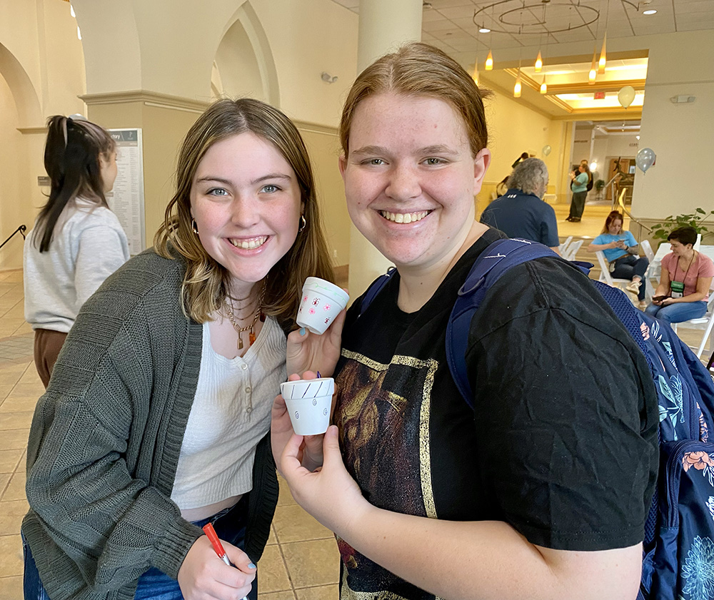 Students decorate pots for the succulents at the Pioneer Pause.