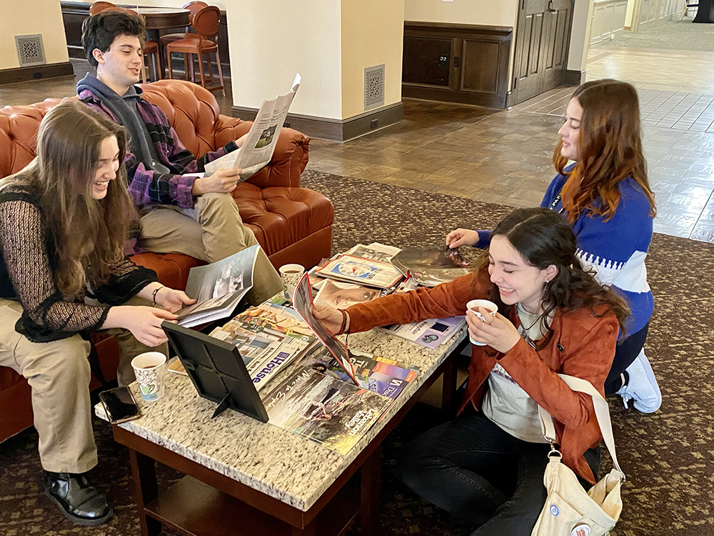 Pictured are four students in the Lawrence Hall lounge at the vision board station during Pioneer Pause.