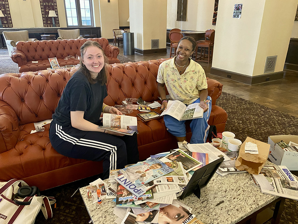 Two students make vision board collages in the Lawrence Hall lounge. Photo by Nicole Chynoweth.