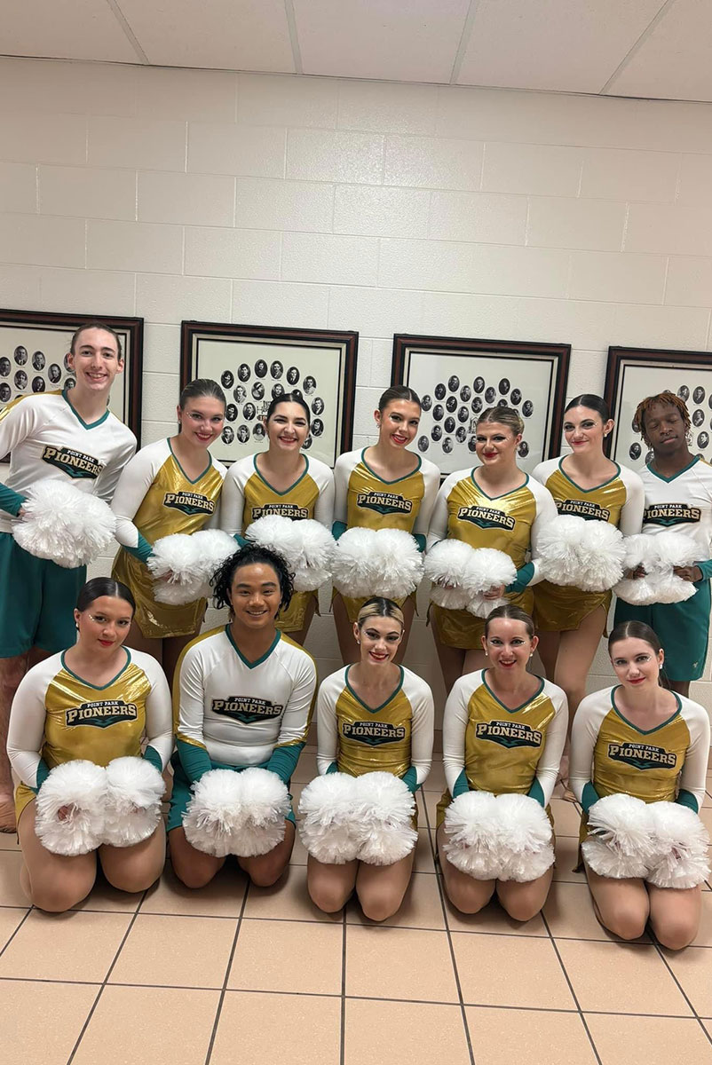 The team poses in a hallway.