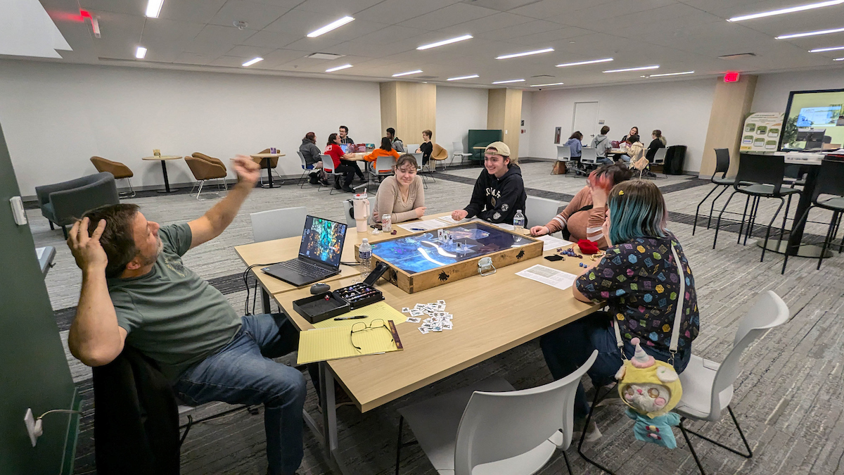 Staff and students play a role playing game.
