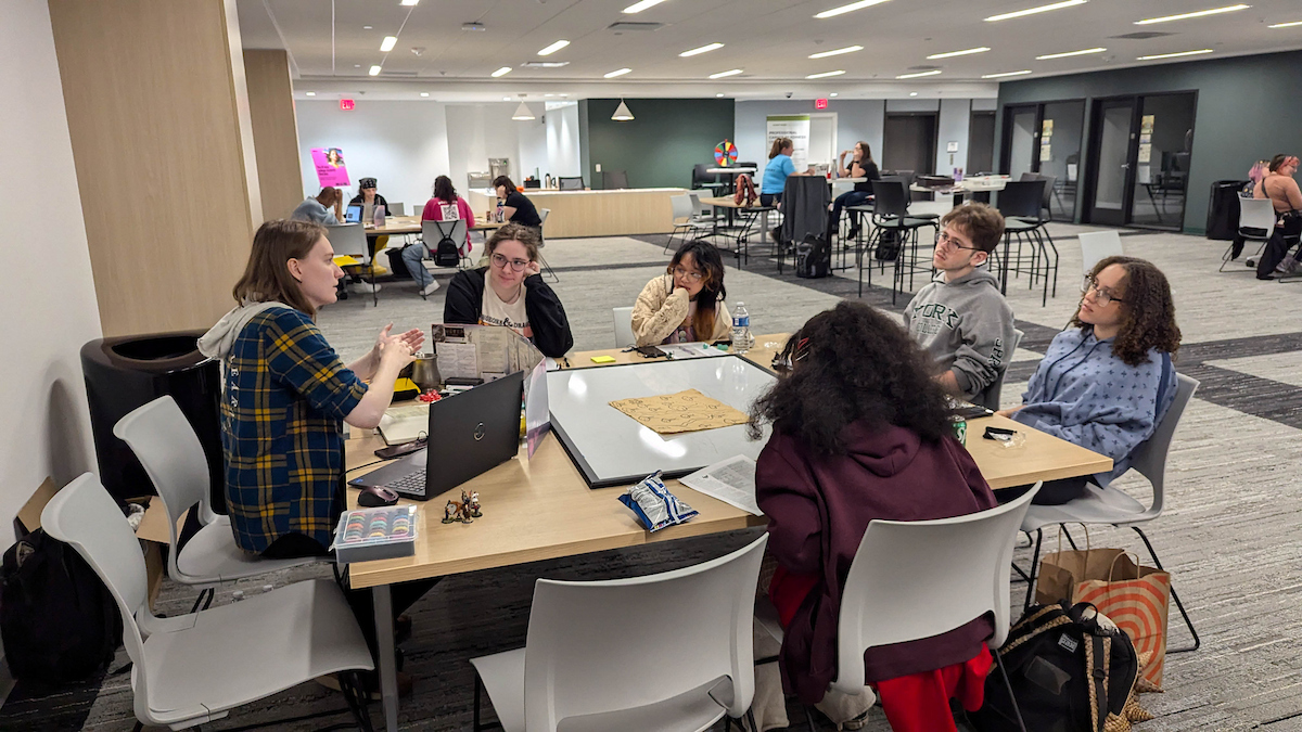 Staff and students play a role playing game.
