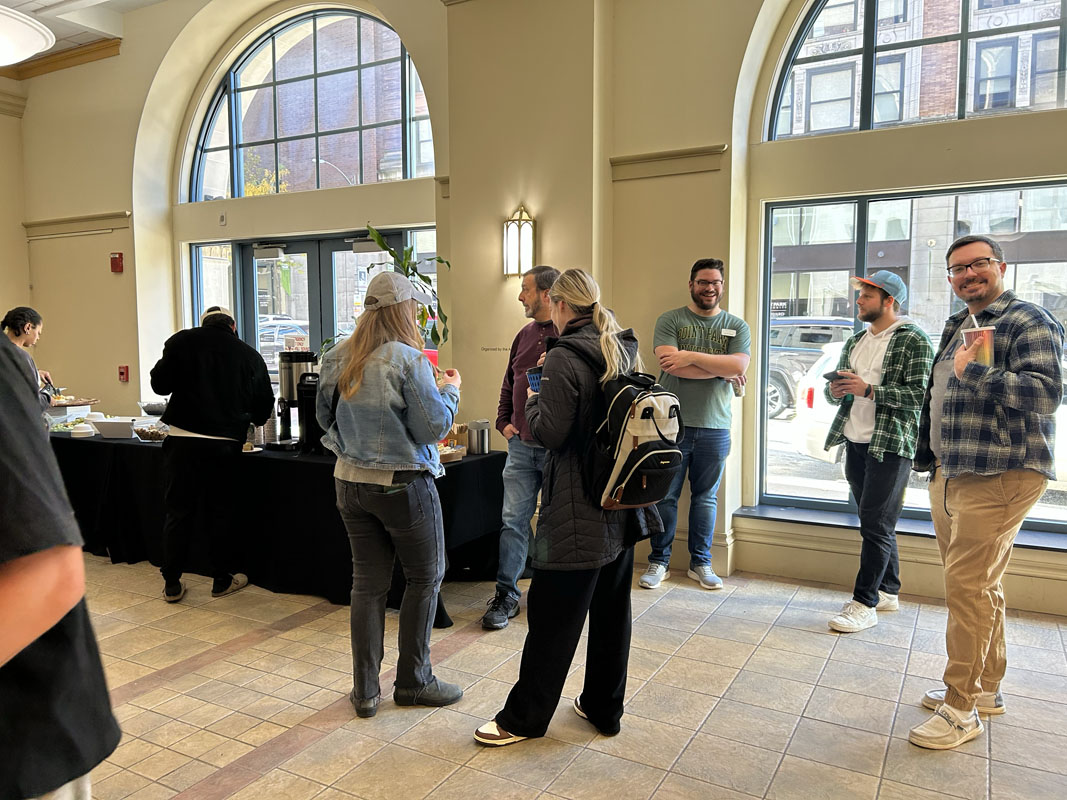 People visit in a lobby.