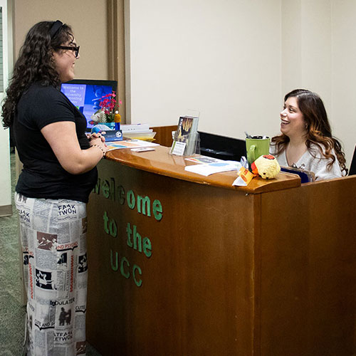 A student checks in at the counseling center front desk.