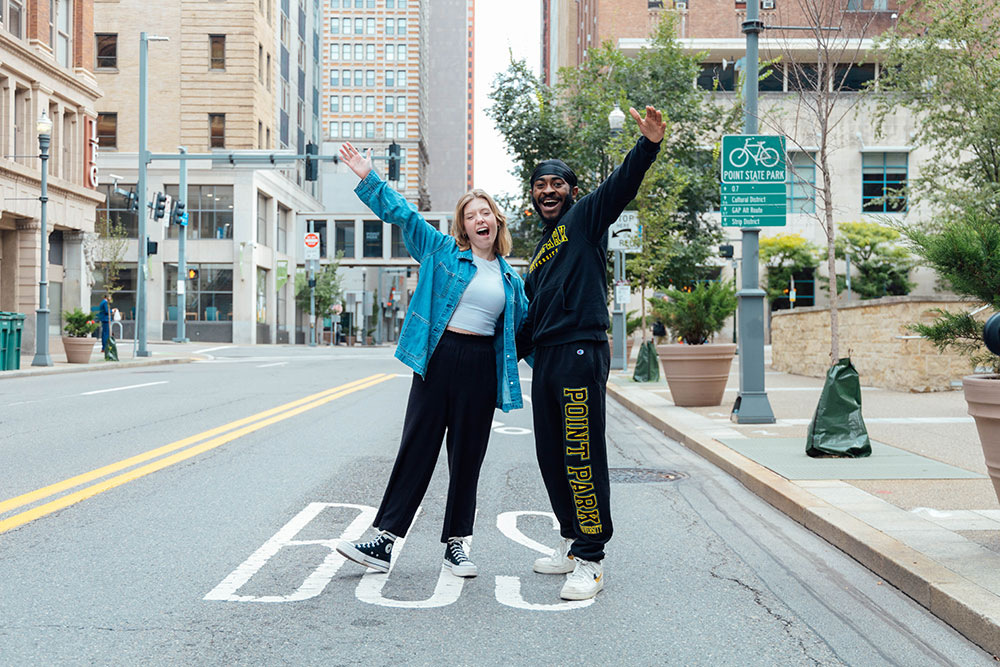 Two students walk along Wood Street.