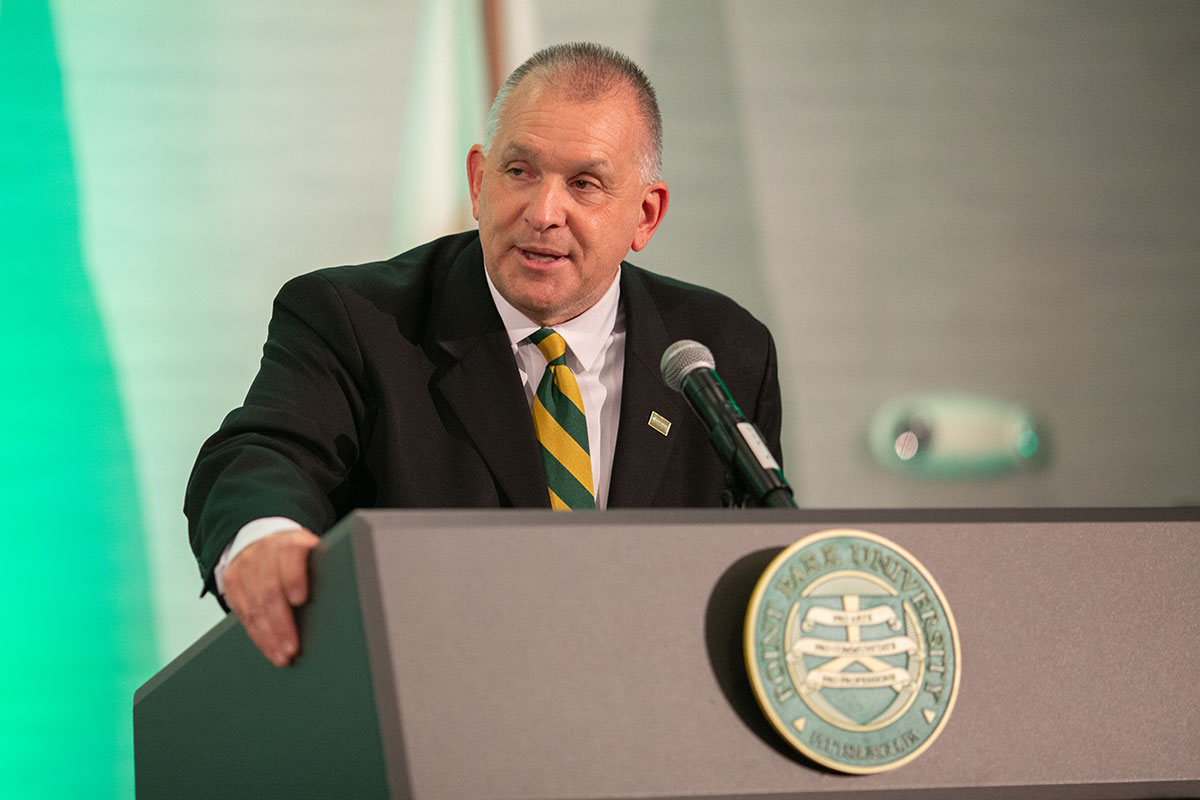 A man speaks at a podium.