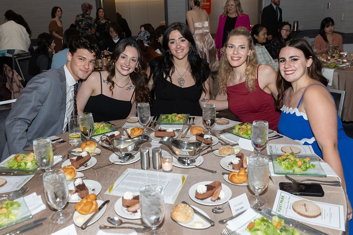 Student gather around a table