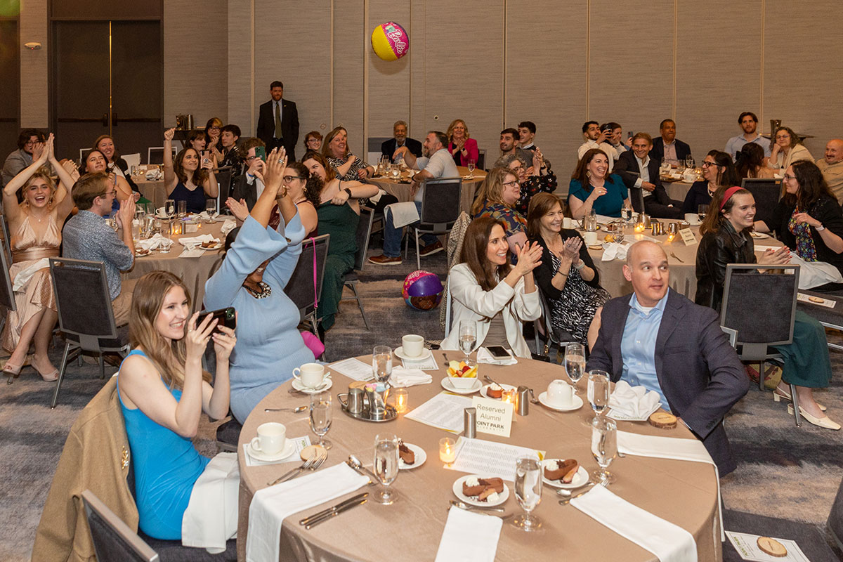 A beach ball is passed around a room full of people