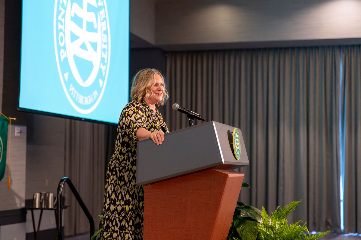 Jessica McCort speaks from a podium. 